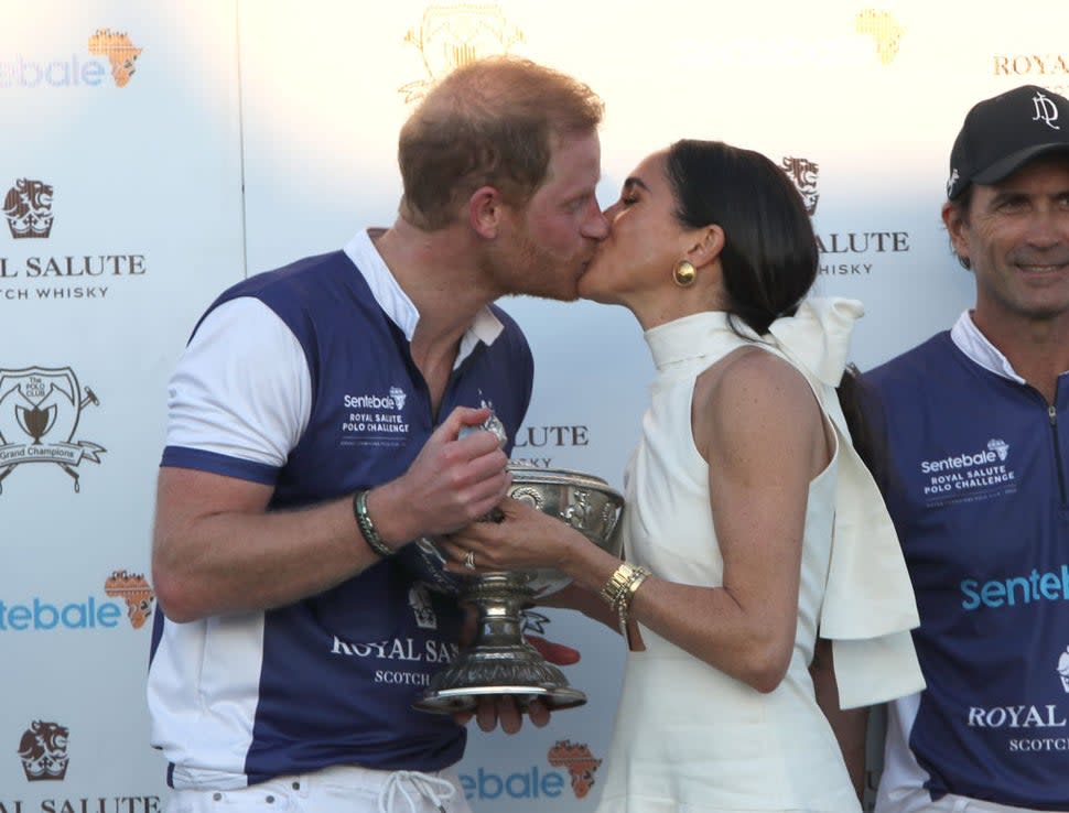 The Duchess of Sussex presents the trophy to her husband, the Duke of Sussex after his team the Royal Salute Sentebale Team defeated the Grand Champions Team, in the Royal Salute Polo Challenge, to benefit Sentebale, at The USPA National Polo Center in Wellington, Florida, US