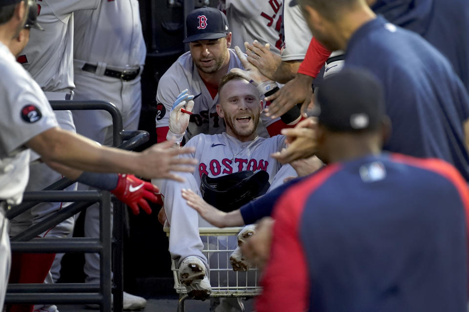 Boston Red Sox's Trevor Story celebrates in the dugout his home run off Chicago White Sox starting pitcher Dallas Keuchel during the second inning of a baseball game Thursday, May 26, 2022, in Chicago. (AP Photo/Charles Rex Arbogast)