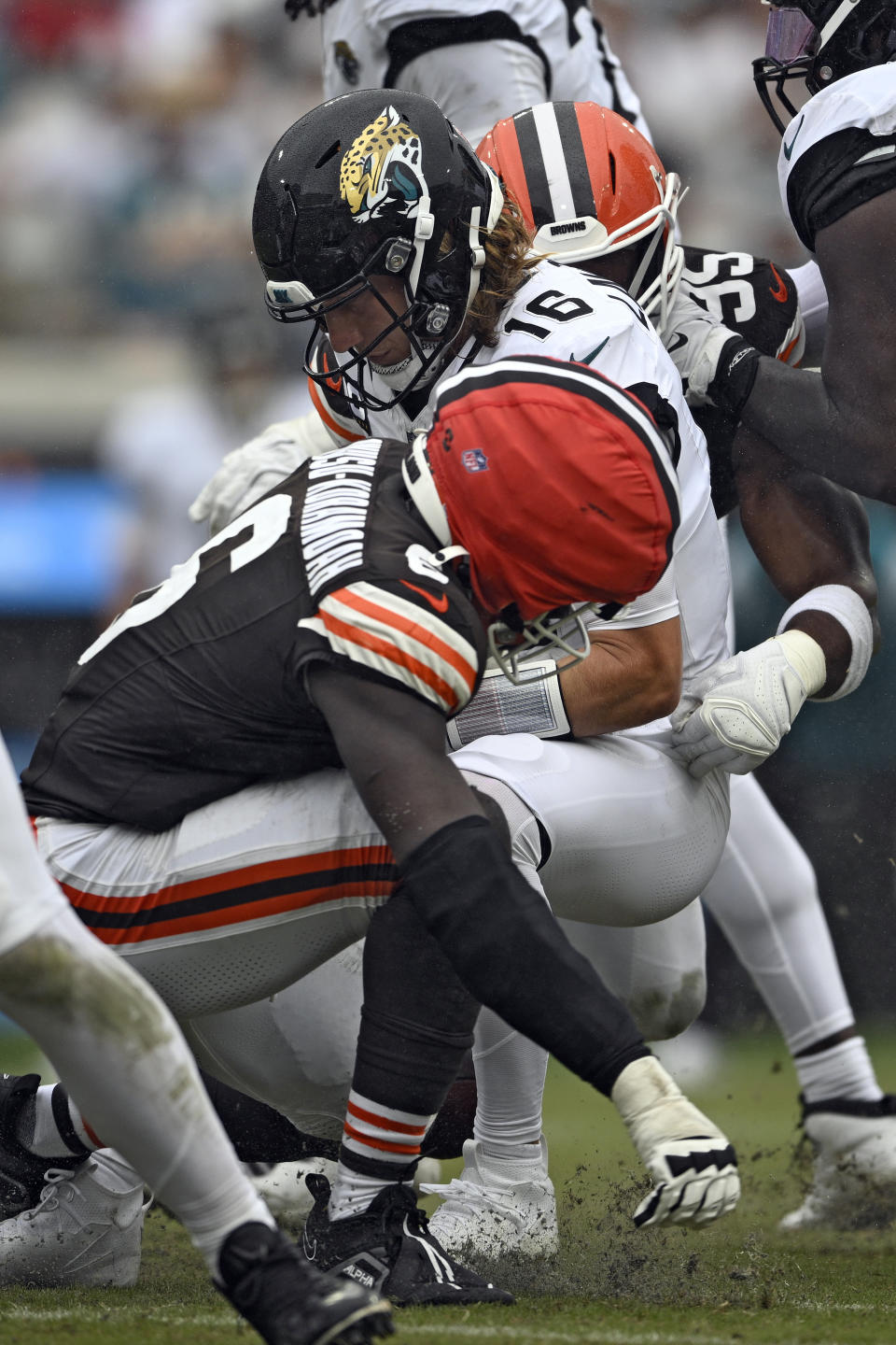 Jacksonville Jaguars quarterback Trevor Lawrence (16) is sacked by Cleveland Browns linebacker Jeremiah Owusu-Koramoah (6) and defensive end Myles Garrett (95) during the second half of an NFL football game Sunday, Sept. 15, 2024, in Jacksonville, Fla. (AP Photo/Phelan M. Ebenhack)