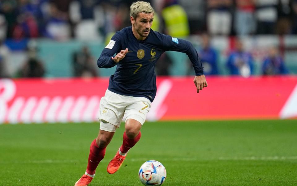 France's Antoine Griezmann goes with the ball during the World Cup quarterfinal soccer match between England and France, at the Al Bayt Stadium - AP