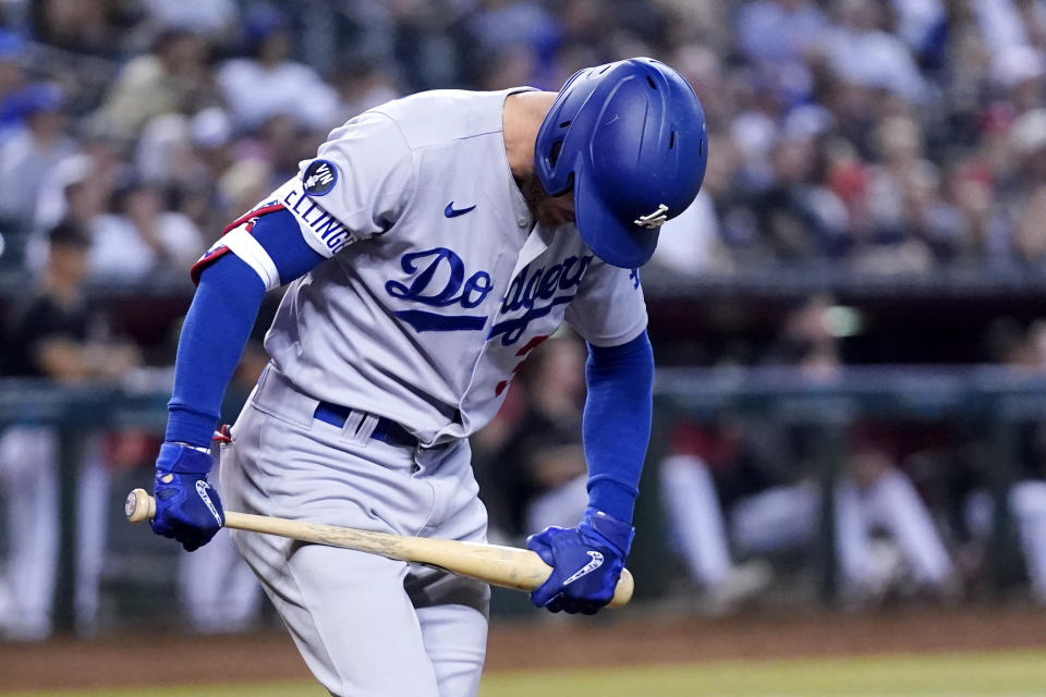 Los Angeles Dodgers' Cody Bellinger tries to break his bat as he flies out during the fourth inning of the team's baseball game against the Arizona Diamondbacks in Phoenix, Wednesday, Sept. 14, 2022. (AP Photo/Ross D. Franklin)