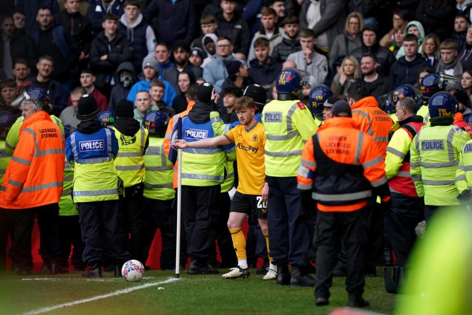 Wolves’ Tommy Doyle attempts to take a corner while surrounded by police officers and stewards during the Emirates FA Cup fourth-round match at the Hawthorns (Bradley Collyer/PA Wire)