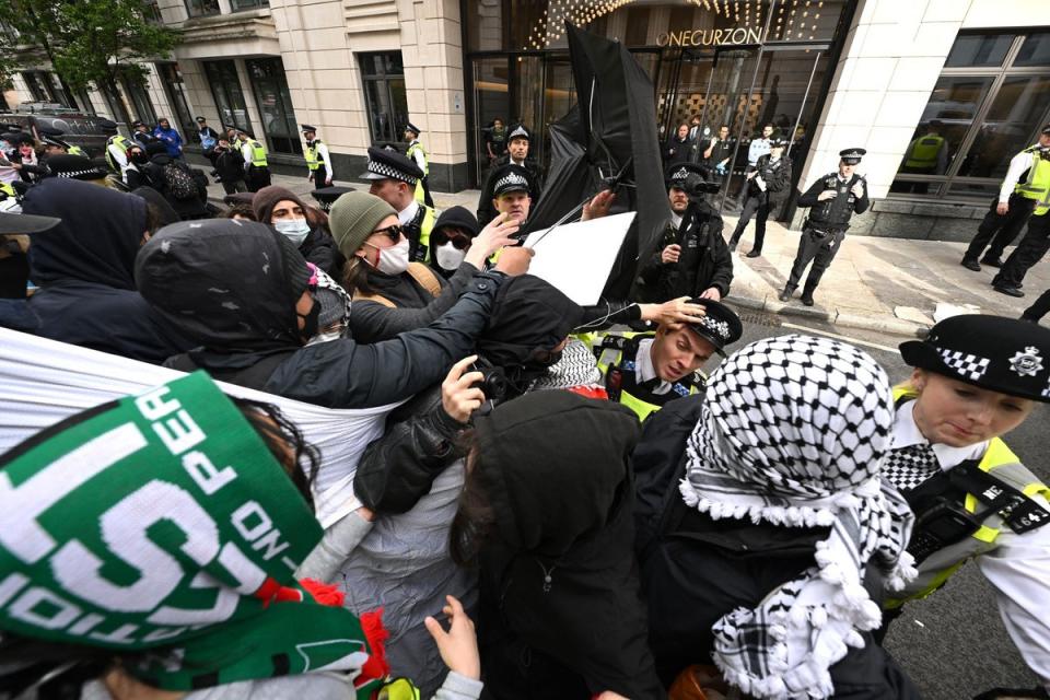 Pro-Palestinian protesters clash with police officers outside One Curzon during a demonstration on April 15 (Getty Images)