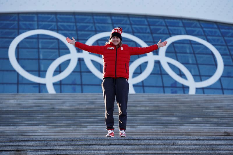 FILE PHOTO: Team Canada women's ice hockey player and Canadian flag bearer Wickenheiser poses in front of the Olympic rings at Bolshoy Ice Dome ahead of the 2014 Sochi Winter Olympics