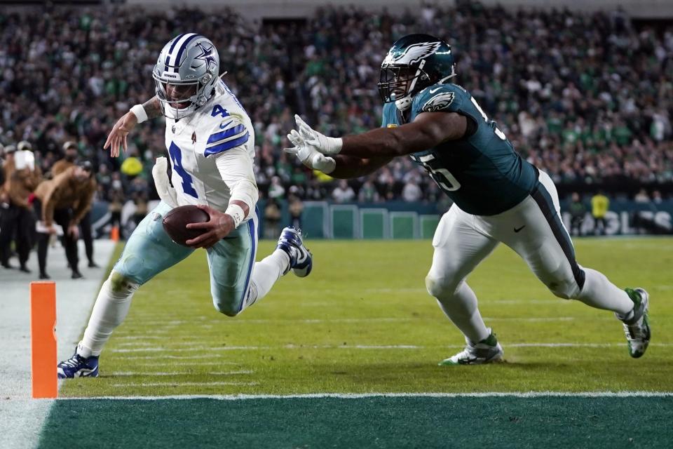 Dallas Cowboys quarterback Dak Prescott (4) steps out of bounds while going for a 2-point conversion in front of Philadelphia Eagles defensive end Brandon Graham (55) during the second half of an NFL football game Sunday, Nov. 5, 2023, in Philadelphia. (AP Photo/Matt Slocum)