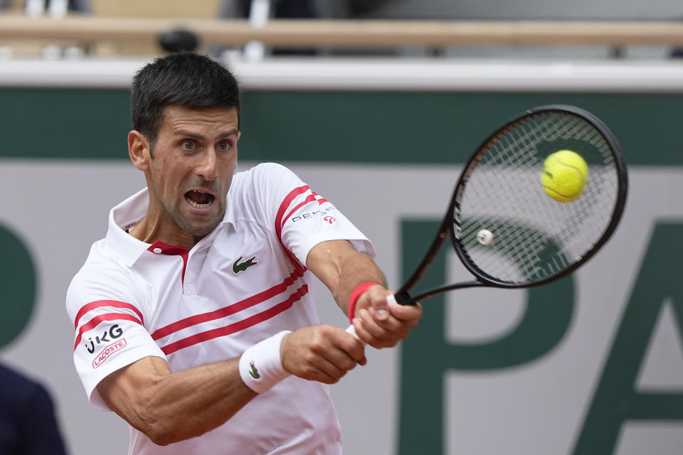 Serbia's Novak Djokovic plays a return to Italy's Lorenzo Musetti during their fourth round match on day 9, of the French Open tennis tournament at Roland Garros in Paris, France, Monday, June 7, 2021. (AP Photo/Michel Euler)
