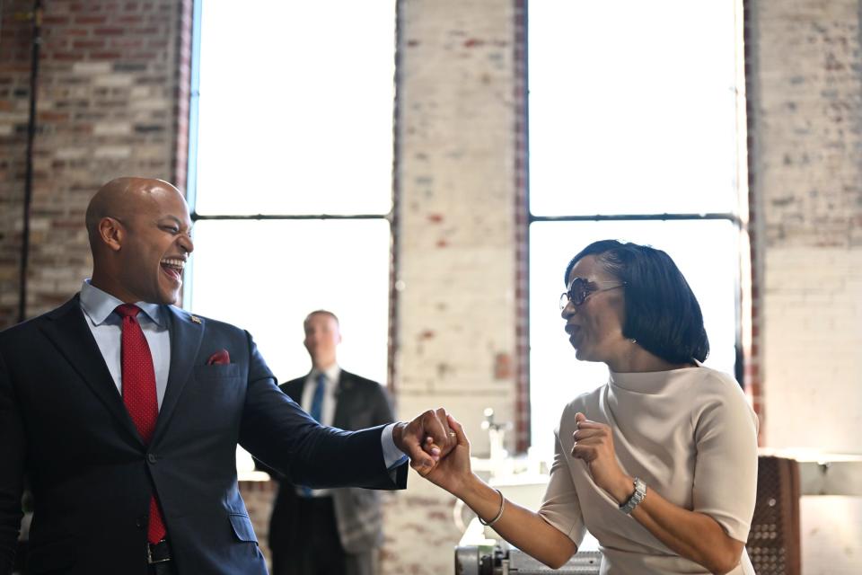 Maryland Gov. Wes Moore, left, holds the hand of Angela Alsobrooks at an event in Baltimore last week. Moore endorsed Alsobrooks, currently Montgomery County executive, in her bid for U.S. Senate.