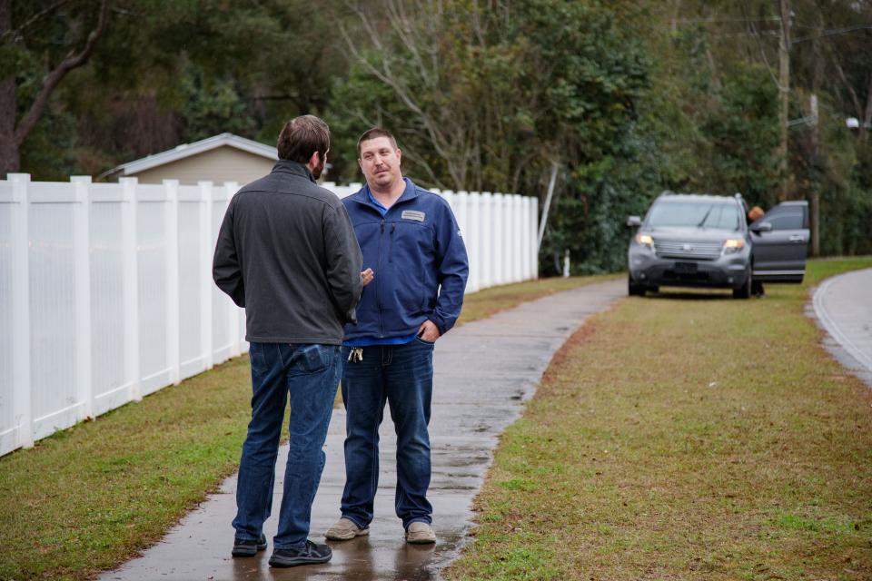 A Florida Sun Estates security guard speaks with Commissioner Jeremy Matlow after forcing media and residents to move to the sidewalk during a press conference regarding the impacts of the rent increase at the mobile home park Tuesday, Jan. 25, 2022. 
