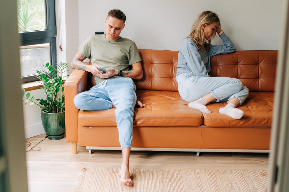 Couple not speaking on the sofa. (Getty Images)