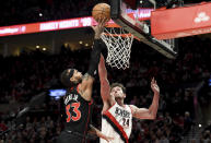 Toronto Raptors guard Gary Trent Jr., left, drives to the basket against Portland Trail Blazers forward Drew Eubanks during the first half of an NBA basketball game in Portland, Ore., Saturday, Jan. 28, 2023. (AP Photo/Steve Dykes)