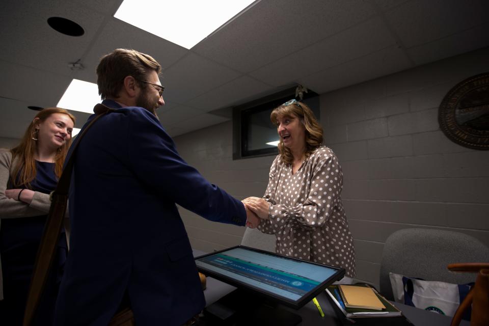 Dr. Lisa Ventura shakes hands with Director of Finance Doug Lukonen after being named Superintendent of Maury County Public Schools during a board meeting at Horace O. Porter School in Columbia, Tenn., on Tuesday, May 3, 2022.