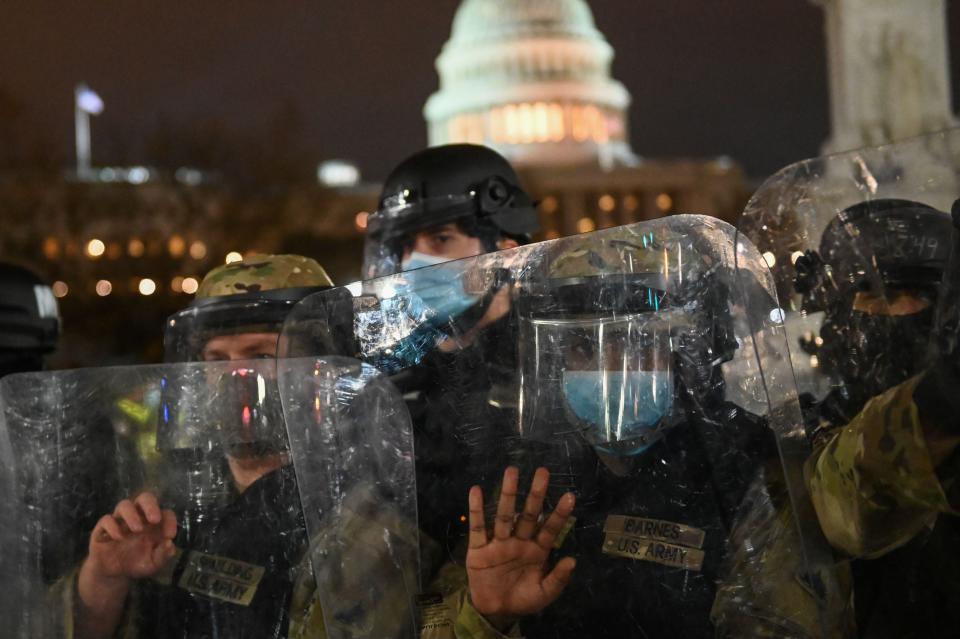 National Guard troops clear a street outside the Capitol building on Jan. 6. (Photo: Roberto Schmidt/AFP via Getty Images)