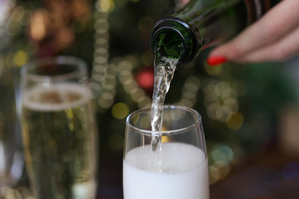 Champagne being poured from bottle into a champagne flute