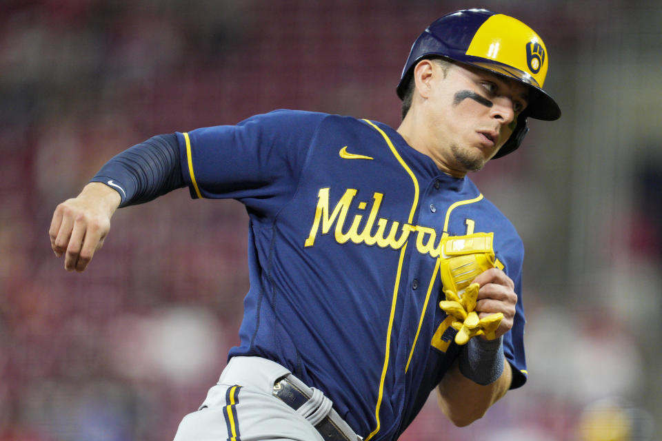 Milwaukee Brewers' Luis Urias (2) rounds third base and scores on a Tyrone Taylor single during the fourth inning of a baseball game against the Cincinnati Reds, Saturday, Sept. 24, 2022, in Cincinnati. (AP Photo/Jeff Dean)