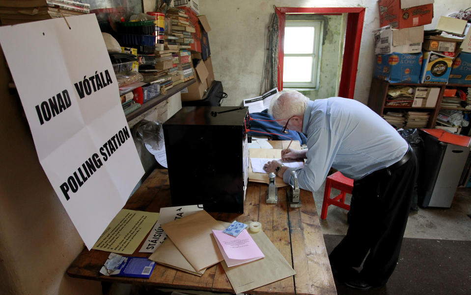 Presiding officer Hugh O' Donnell, right prepares the ballot box on Inishfree Island, county Donegal, Ireland, Monday, May 28, 2012. Barry Edgar Pilcher an artist is the only inhabitant on the island and is using his living room as a polling station to vote in the European Fiscal Treaty Referendum, many island's around Ireland voted Monday ahead of the mainland voting on Thursday. (AP Photo/Peter Morrison)