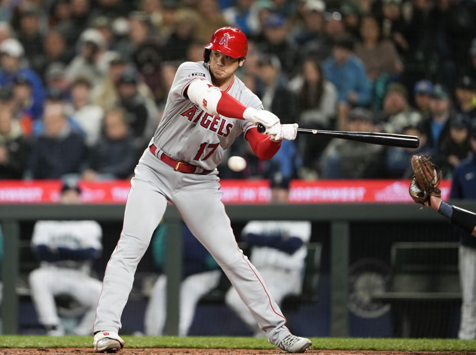 Los Angeles Angels' Shohei Ohtani checks his swing and draws a walk from Seattle Mariners starting pitcher Luis Castillo during the sixth inning of a baseball game Tuesday, April 4, 2023, in Seattle. The Mariners won 11-2. (AP Photo/Lindsey Wasson)
