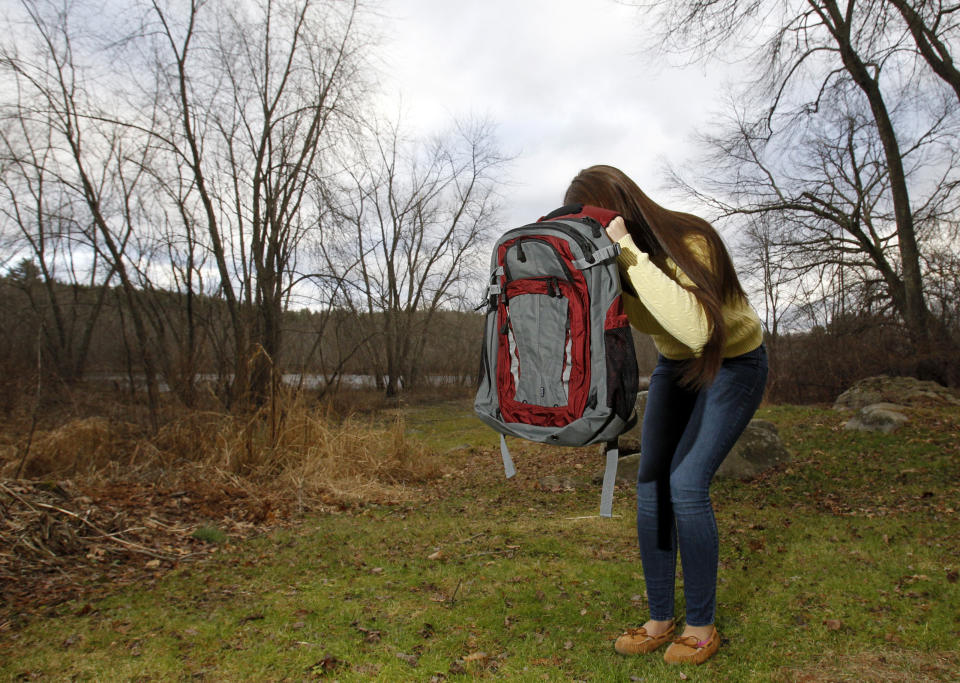 Amanda Curran, daughter of Bullet Blocker inventor Joe Curran, demonstrates how to use a child's bulletproof backpack in the event of a shooting.&nbsp; (Photo: Jessica Rinaldi / Reuters)