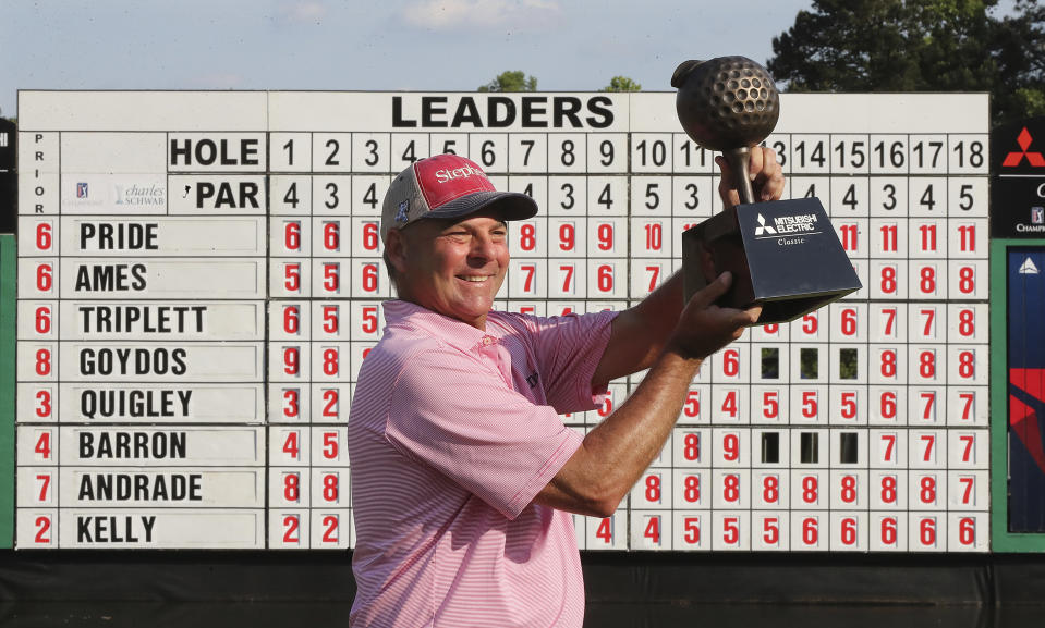 Dicky Pride hoists the trophy on the 18th green after winning the PGA Tour Champions’ Mitsubishi Electric Classic golf tournament at TPC Sugarloaf on Sunday, May 16, 2021, in Duluth, Ga. (Curtis Compton/Atlanta Journal-Constitution via AP)