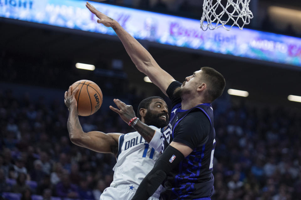 Dallas Mavericks guard Kyrie Irving (11) prepares to pass as Sacramento Kings center Alex Len (25) defends in the first half of an NBA basketball game in Sacramento, Calif., Tuesday, March 26, 2024. (AP Photo/José Luis Villegas)