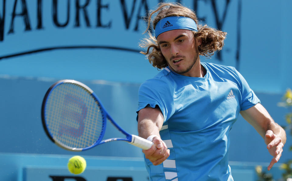 Stefanos Tsitsipas of Greece returns to Jeremy Chardy of France during their singles match at the Queens Club tennis tournament in London, Thursday, June 20, 2019.(AP Photo/Frank Augstein)