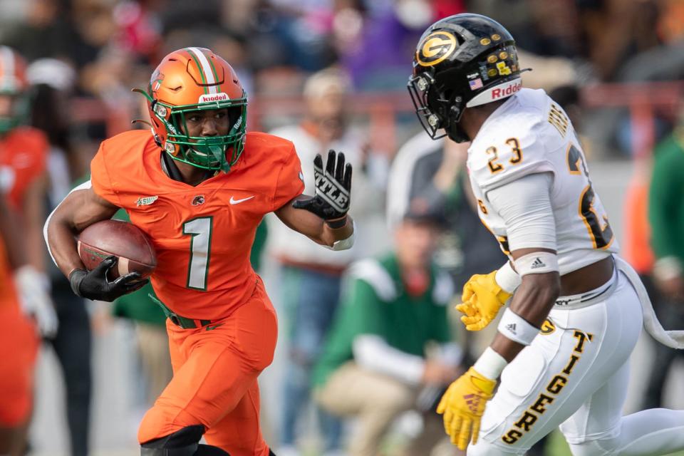 Florida A&M Rattlers running back Bishop Bonnett (1) blocks as he runs the ball during a game between FAMU and Grambling State University at Bragg Memorial Stadium on FAMU's homecoming Saturday, Oct. 30, 2021.