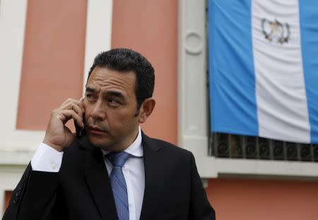 Guatemalan presidential candidate Jimmy Morales of the National Convergence Front, speaks on a mobile phone outside the Supreme Electoral Tribunal (TSE) in Guatemala City, October 21, 2015. REUTERS/Jorge Dan Lopez