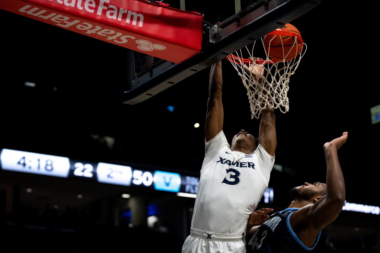 Xavier Musketeers guard-forward Dailyn Swain (3) dunks over Villanova Wildcats forward Eric Dixon (43) in the second half of the NCAA basketball game between Xavier Musketeers and Villanova Wildcats at the Cintas Center in Cincinnati on Wednesday, Feb. 7, 2024.