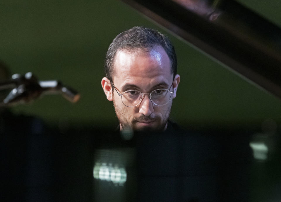 FILE - In this Nov. 9, 2018 file photo, Russian-German pianist Igor levit plays at the Green party convention in Leipzig, Germany. The 32-year-old pianist, winner of last year’s Gilmore Artist Award, is among the most probing young artists in classical music. (AP Photo/Jens Meyer, File)