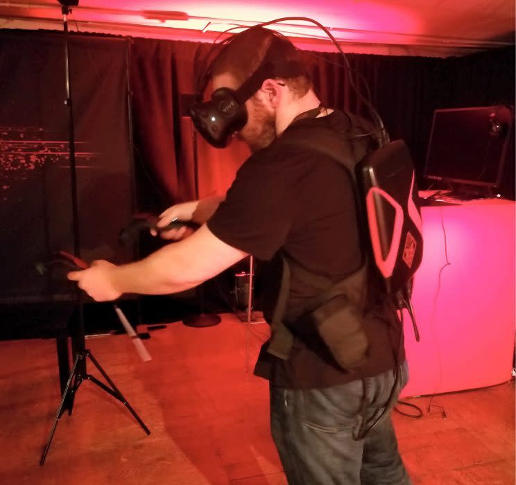 A man wearing the HP Omen X VR PC Pack 