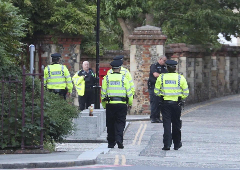 Police arrive at Forbury Gardens in the town centre of Reading, England, where they are responding to a "serious incident" Saturday, June 20, 2020. (Steve Parsons/PA via AP)