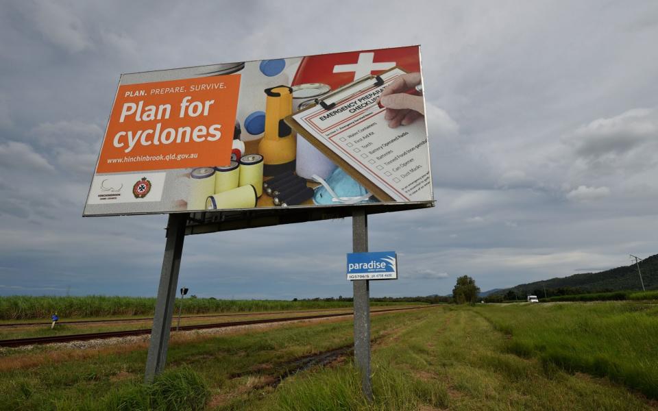 A cyclone warning sign is seen outside the city of Townsville in far north Queensland - Credit: AFP