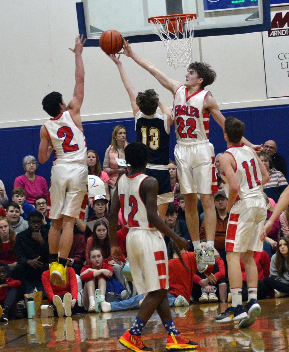 Heritage's Caleb Stamper (22) blocks a shot by Shalom's Ethan Hubers (13) during the Mason Dixon Christian Conference boys basketball tournament final.