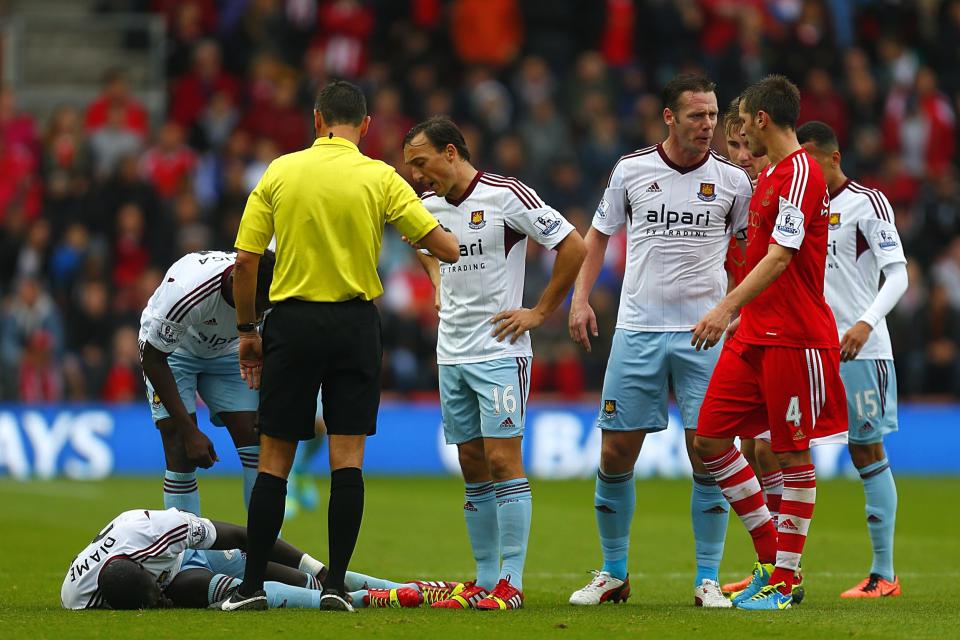 West Ham United players exchange heated words with Southampton's Morgan Schneiderlin (right) as teammate Mohamed Diame lies on the floor