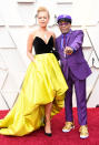 <p><i>BlacKkKlansman</i> helmer Spike Lee, a nominee for directing, hit the carpet with his wife, Tonya Lewis Lee, in a purple suit, as a tribute to Prince. He accessorized with a necklace of Prince’s love symbol, as well as knuckle rings that made a statement, reading “love” and “hate.” (Photo: Getty Images) </p>