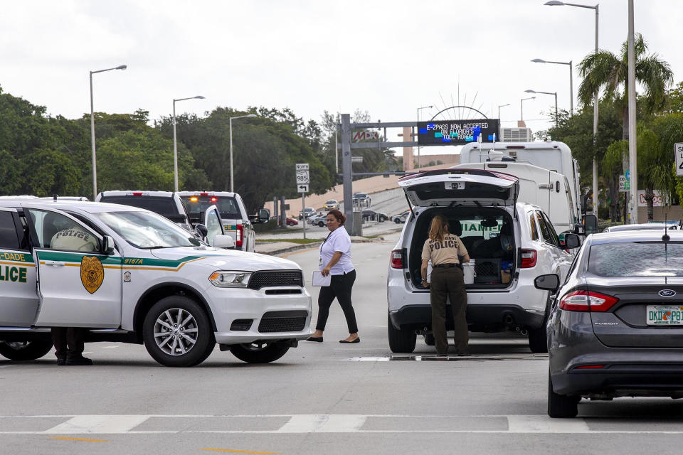 Police block an intersection near the Miami-Dade Kendall Campus in Miami, Fla., on Sunday, June 6, 2021. Three people are dead and at least six others injured following a shooting at a Florida graduation party, the latest in a string of such violence in the Miami area, police said Sunday. One of those killed was a state corrections officer, Miami-Dade police Director Freddie Ramirez told news outlets. (Daniel A Varela/Miami Herald via AP)