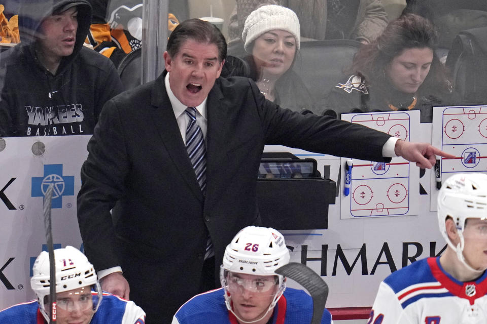 New York Rangers head coach Peter Laviolette makes his point to a linesman during the first period of an NHL hockey game against the Pittsburgh Penguins in Pittsburgh, Wednesday, Nov. 22, 2023. (AP Photo/Gene J. Puskar)