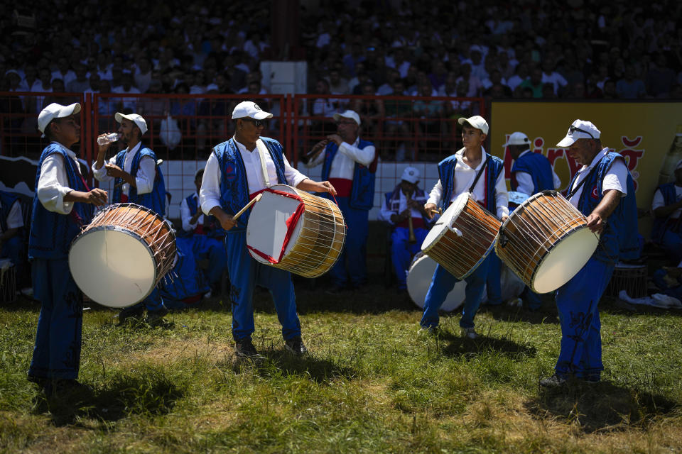 Band members play traditional music during the 663rd annual Historic Kirkpinar Oil Wrestling championship, in Edirne, northwestern Turkey, Saturday, July 6, 2024. Wrestlers take part in this "sudden death"-style traditional competition wearing only a pair of leather trousers and a good slick of olive oil. The festival is part of UNESCO's List of Intangible Cultural Heritages. (AP Photo/Khalil Hamra)