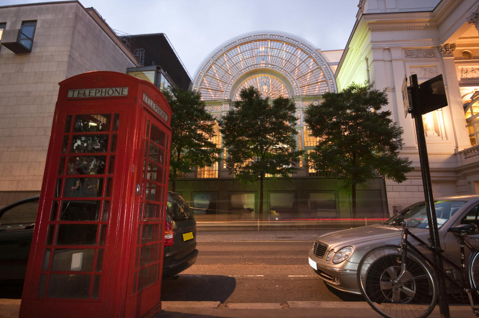 "The Paul Hamlyn Hall is a large iron and glass structure adjacent to, and with direct access to the main opera house building. Historically it formed part of the old Covent Garden flower market, and is still commonly known as the 'floral hall', but it was absorbed into the Royal Opera House complex during the 90s redevelopment. The hall now acts as the atrium and main public area of the opera house, with a champagne bar, restaurant and other hospitality services, and also providing access to the main auditorium at all levels."