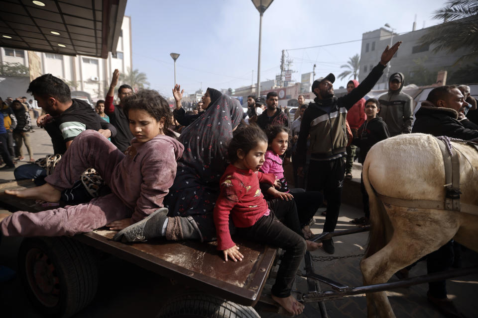 Palestinians wounded during the Israeli bombardment of the Gaza Strip are brought over a donkey carte to the Nasser hospital in Khan Younis, Southern Gaza Strip, Monday, Jan. 22, 2024. (AP Photo/Mohammed Dahman)