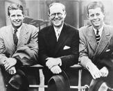 <p>U.S. Ambassador to Great Britain Joseph P. Kennedy, center, is flanked by his sons, Joseph P. Kennedy Jr., left, and John F. Kennedy, right, as he poses aboard an ocean liner in this 1938 photograph. (Photo: AP) </p>