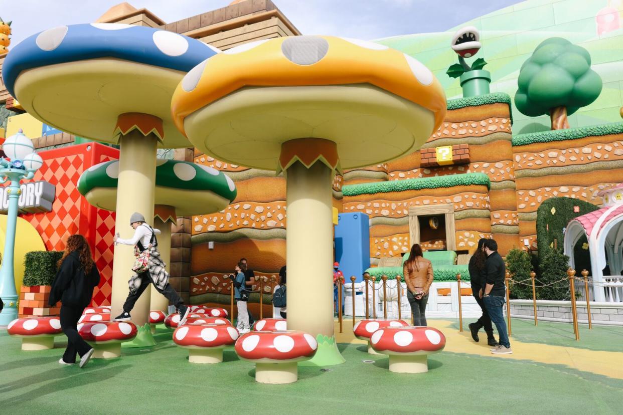 People play on top of the large mushrooms for the tech rehearsals at Super Nintendo World.