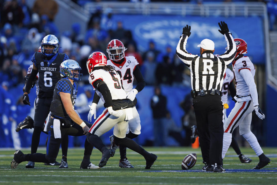 Georgia defensive back Kelee Ringo (5) looks at Kentucky quarterback Will Levis after intercepting his pass and being tackled by him during the first half of an NCAA college football game in Lexington, Ky., Saturday, Nov. 19, 2022. (AP Photo/Michael Clubb)