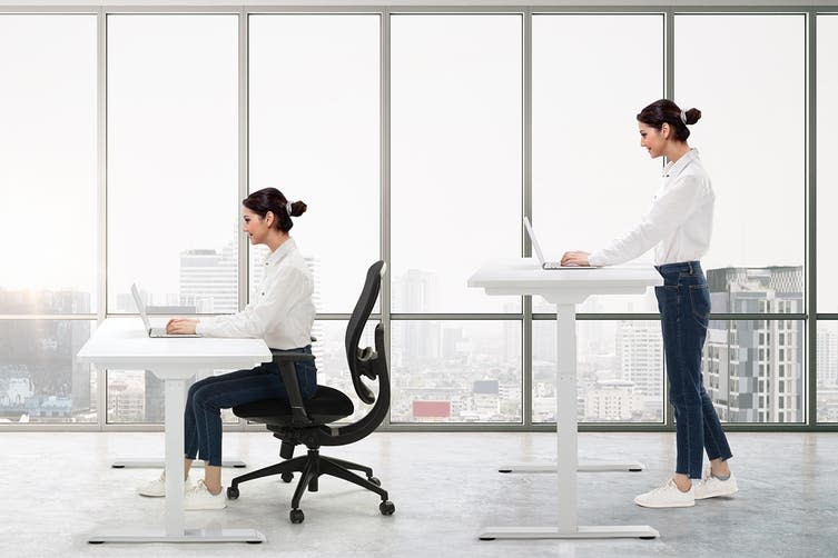 Woman using a standing desk on sale for EOFY 2021