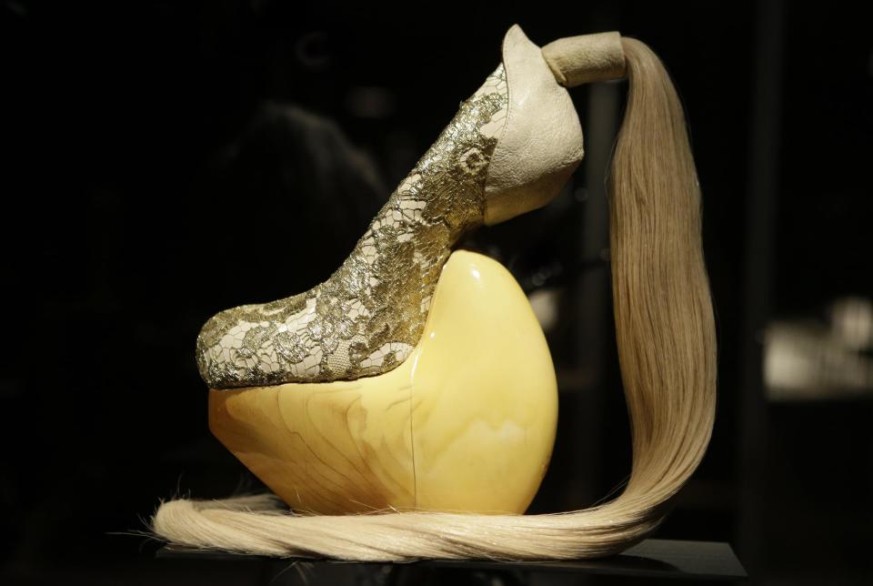 This Feb. 11, 2013 photo shows a shoe, designed by Masaya Kushino, and made with lacquered Japanese cypress wood, human hair, and lace, displayed at the "Shoe Obsession" exhibit at The Museum at the Fashion Institute of Technology Museum in New York. The exhibition, showing off 153 specimens, runs through April 13. (AP Photo/Kathy Willens)