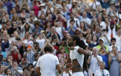 Dustin Brown touches his tattoo after beating Rafael Nadal. (AP)