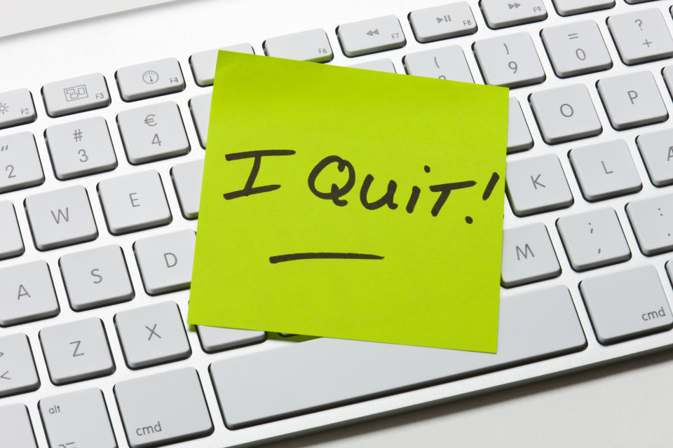 Post-it note with "I Quit!" handwritten, placed on a computer keyboard, indicating resignation