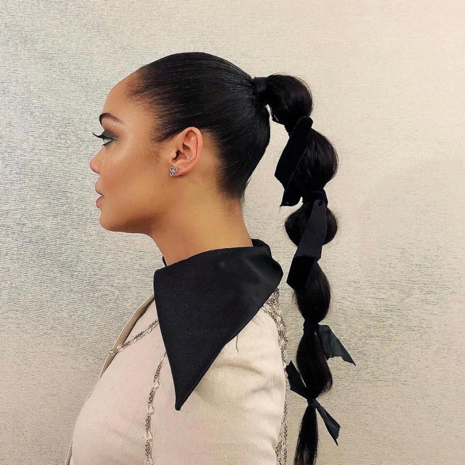 Technically this is a ponytail, not a braid, but the puffed-up sections give the same illusion. We love how the little bows dress up an otherwise sporty look.