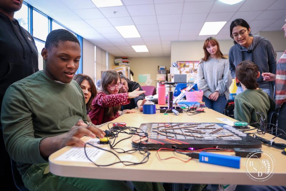 A Brandywine High School team tests its assistive board game project — so far adapted electronic games similar to "Connect 4" and "Chutes and Ladders" — for Samsung's Solve for Tomorrow STEM Competition, as the Delaware high school clinched a top-10 spot among national finalists in late March 2024.