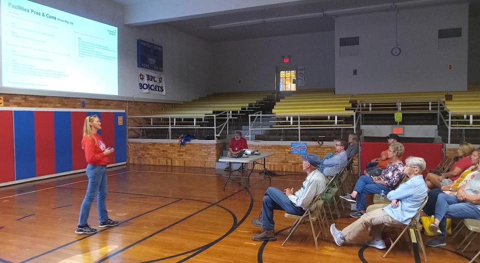 Lakeville resident and facility advisory committee member Laura Nowels Kaster speaks to Lakeville residents at the community meeting at the elementary school on Thursday.