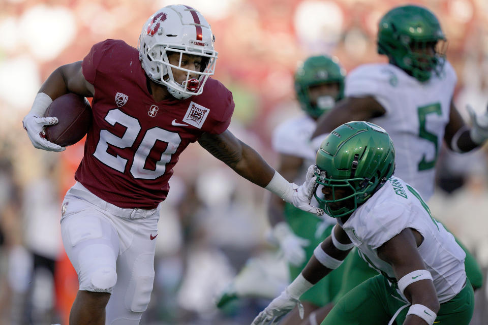 FILE - In this Sept. 21, 2019, file photo, Stanford running back Austin Jones (20) stiff-arms Oregon cornerback Thomas Graham Jr. (4) during the second half of an NCAA college football game in Stanford, Calif. Stanford head coach David Shaw has a long list of capable sophomores who gained valuable experience even if some didn't play and will be called upon to take on bigger roles now in their second seasons. Jones finished with 227 yards rushing with one touchdown on 45 carries and also made 14 catches for 108 yards. (AP Photo/Tony Avelar, File)